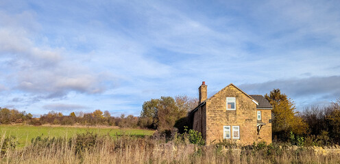 An Abandoned House Sitting In The Middle Of The Countryside