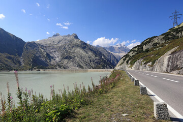 The Grimsel Pass road in the Bernese Alps. View of the reservoir lake Raeterichsbodensee. Canton of Bern, Switzerland