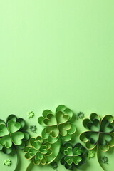 Green paper quilling clovers on a light green background. St. Patrick's Day vertical banner design,...