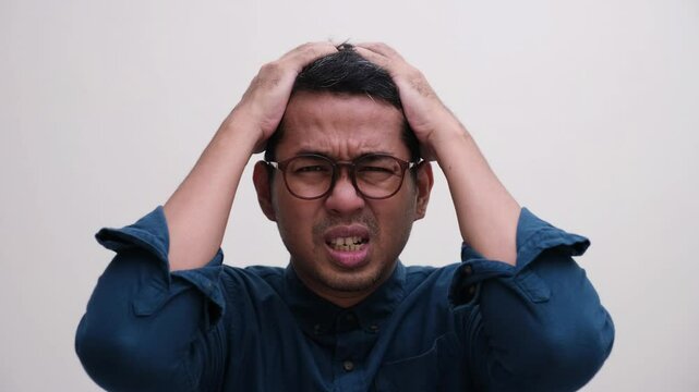Close up shot of a man showing stress expression