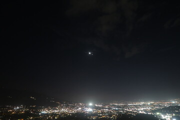 City lights and Venus-Jupiter conjunction at night