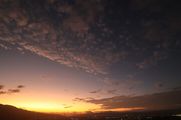 Golden sunset over city with dramatic clouds