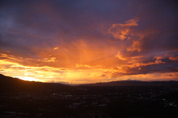 Golden hour sunset over cityscape and mountains
