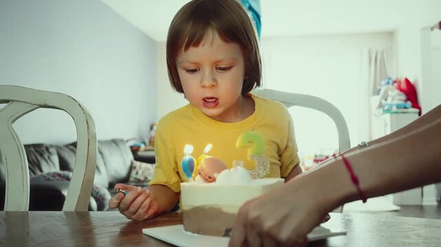 Child Blowing Out Birthday Candles. Slow Motion