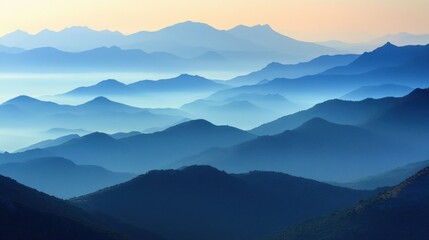 Fototapeta premium Serene mountain landscape with layered blue hues and misty atmosphere at dawn.