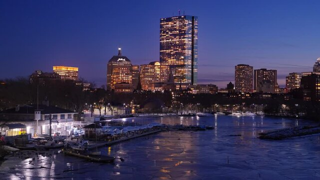 Boston city skyline with high-rise buildings seen from  Longfellow bridge over Charles river during winter sunset