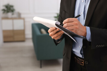 Real estate appraisal. Inspector with clipboard conducting property valuation at home, closeup....