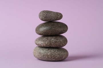 Stack of rocks on lilac background. Harmony and life balance