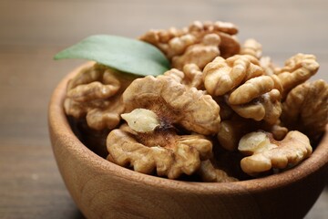 Peeled walnuts in bowl on table, closeup