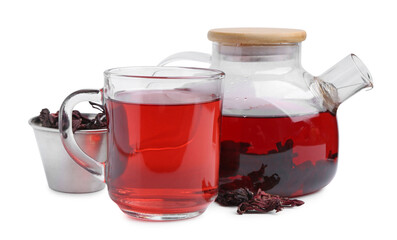 Delicious hibiscus tea in glass cup, teapot and dry roselle sepals isolated on white