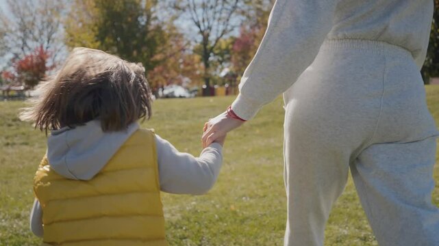 Happy family Mother and Child Walking Smiling Outdoor. Slow motion