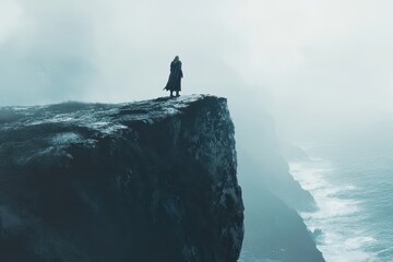 Figure in cloak standing on the edge of a cliff