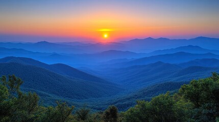 Fototapeta premium Majestic sunrise over a misty mountain range.