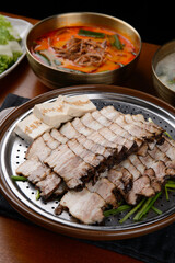 Boiled pork and tofu on a steamer