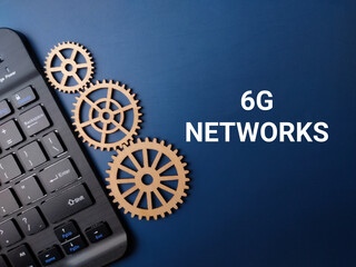 Wooden gear and keyboard with the word 6G NETWORKS on a blue background