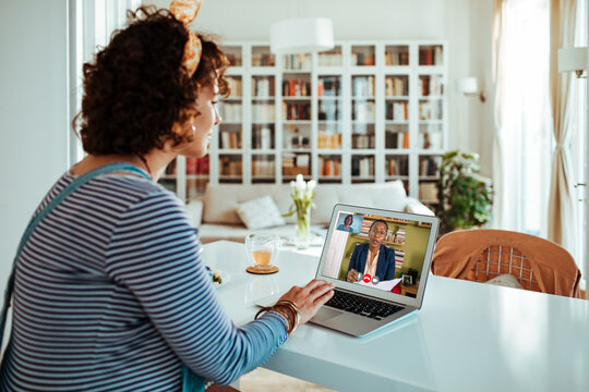 Woman having video call consultation with doctor at home