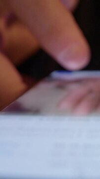 Mindlessly scrolling on smartphone social media app, digital addiction. Vertical