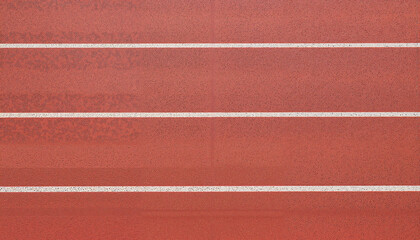 Fototapeta premium Track surface with white lanes in red color