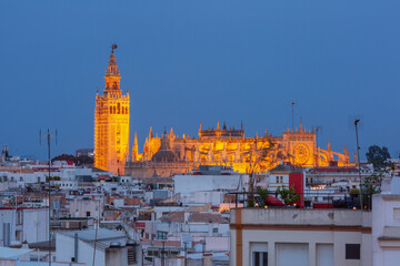 Fototapeta premium Aerial view of Cathedral of Santa Maria de la Sede during blue hour at sunset, Seville, Spain