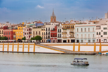 View of the colorful buildings of the Triana district along the Guadalquivir River in Seville, Spain