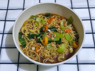 Soy sauce fried noodles served with pickles, chilies, vegetables, etc.