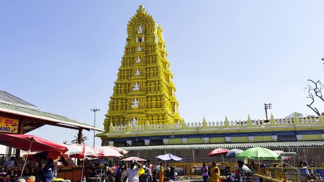 Hindu devotees and the towering gopuram of the Sri Chamundeswari Temple, Mysore, Karnataka, India - 11th february 2025