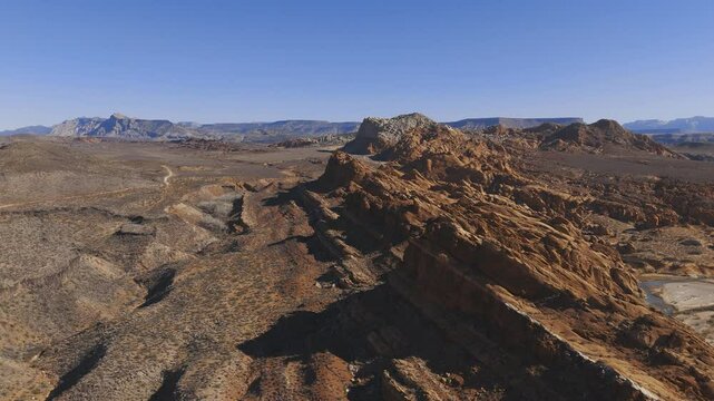 HURRICANE, UTAH, USA - February 07, 2025: Aerial-Pull back-Rugged tilted sandstone geological formation