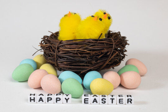 easter chicks in a nest with colourful mini eggs.