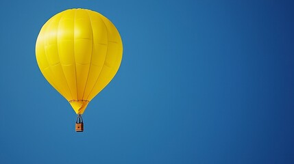 Naklejka premium Solo Yellow Hot Air Balloon Ascending in Clear Blue Sky