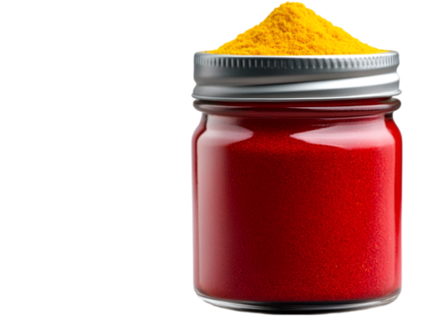 A glass jar filled with vibrant red and yellow powdered spices for cooking.
