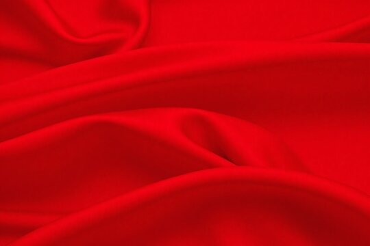 Red fabric flowing in wind with smooth texture and vibrant color