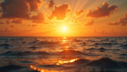 Glowing horizon over the ocean waves during a vibrant sunset with sun rays reflecting on water
