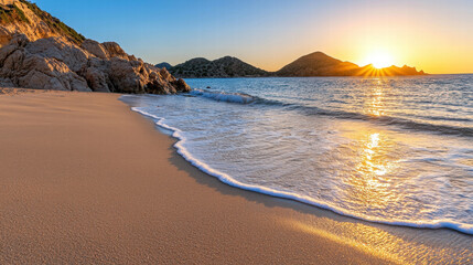 Fototapeta premium A serene beach at sunset, featuring gentle waves lapping against the shore, surrounded by rocky formations and distant hills.