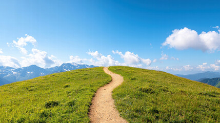 Obraz premium A winding dirt path leads through lush green hills under a bright blue sky with scattered white clouds.