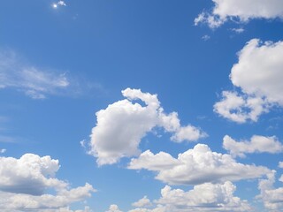 Vibrant blue sky with fluffy white clouds on a sunny day, fluffy, sunny day, blue sky