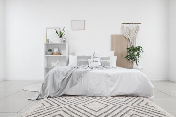 Interior of comfortable modern bedroom with cosy bed