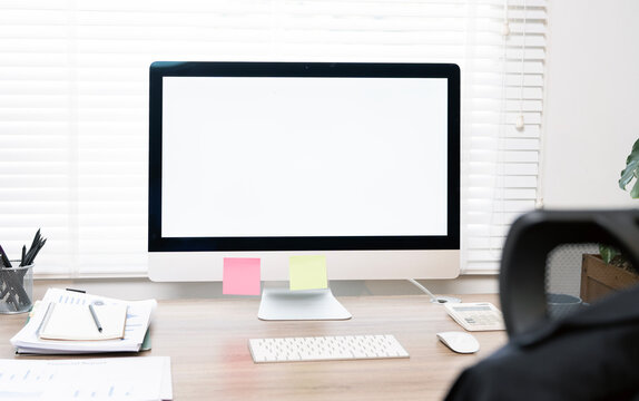 Blank screen computer monitor on the table, home office workspace mockup