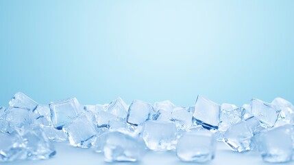 Obraz premium Pile of clear ice cubes on a light blue background.