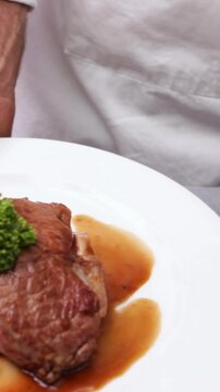 Chef serving up two dinner plates