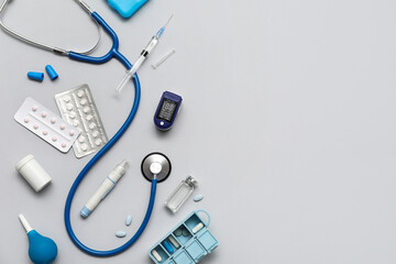 Composition with pulse oximeter, stethoscope and medicines on white background