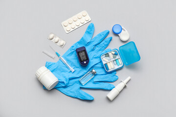 Composition with pulse oximeter, rubber gloves and medicines on white background