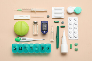 Composition with pulse oximeter, thermometer and medicines on beige background