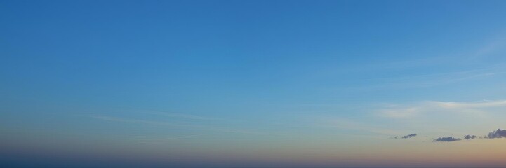 Beautiful blue sky with fluffy white clouds illuminated by the soft morning light, daybreak, horizon, natural