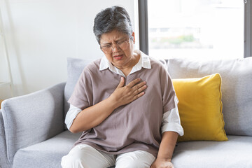 Chest pain, attack chest, emergency heartbeat asian senior woman holding hand on chest, suffering symptom from pain, heart disease problem of aged anxiety cardiac. Health care of cardiology concept.