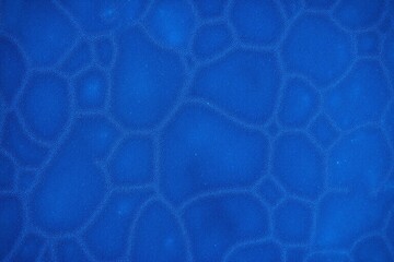 Close up of ice surface blue color rough texture dots