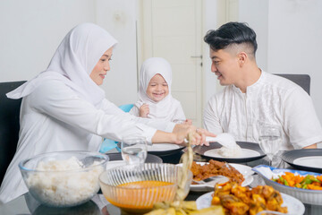 Happy Muslim Family Enjoying Traditional Meal Together at Home