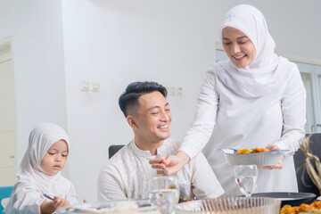Happy Muslim Family Enjoying a Traditional Meal at Home