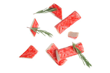Cut tasty crab sticks and rosemary flying on white background © Pixel-Shot