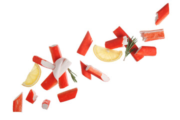 Tasty crab sticks with rosemary and slices of lemon flying on white background © Pixel-Shot