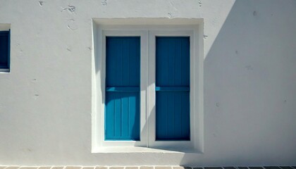 Obraz premium Blue Doors and Shadow on White Building Wall